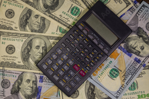Calculator on the American one hundred dollar bills background