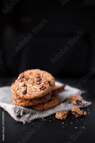 Chocolate chip cookies on dark  with place for text  freshly baked. Selective Focus with Copy space. Heap of  choco cookie.
