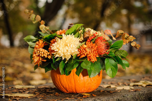 Pumpkin with a beautiful autumn flower composition