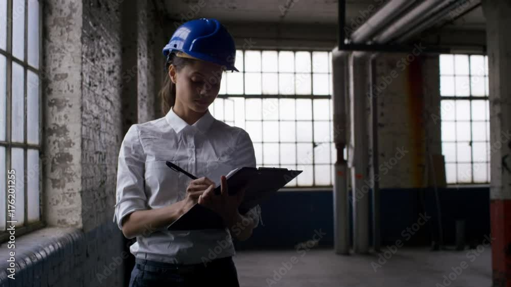  Female architect or engineer inspecting an empty building
