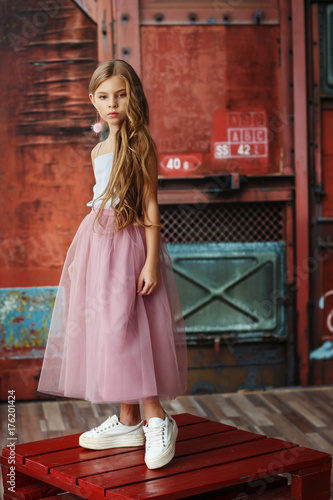 Beautiful girl with wavy hair posing in a dress © Natalia Chircova