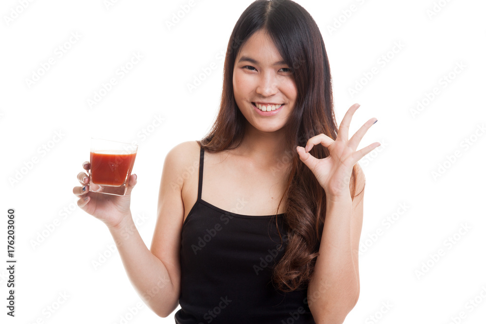 Young Asian woman show OK with tomato juice. Young Asian woman show OK with tomato juice.