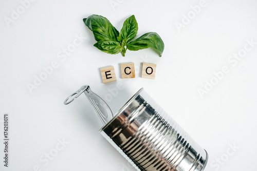 Eco Concept Aluminum Can and Green sprout on the White Background Top View photo