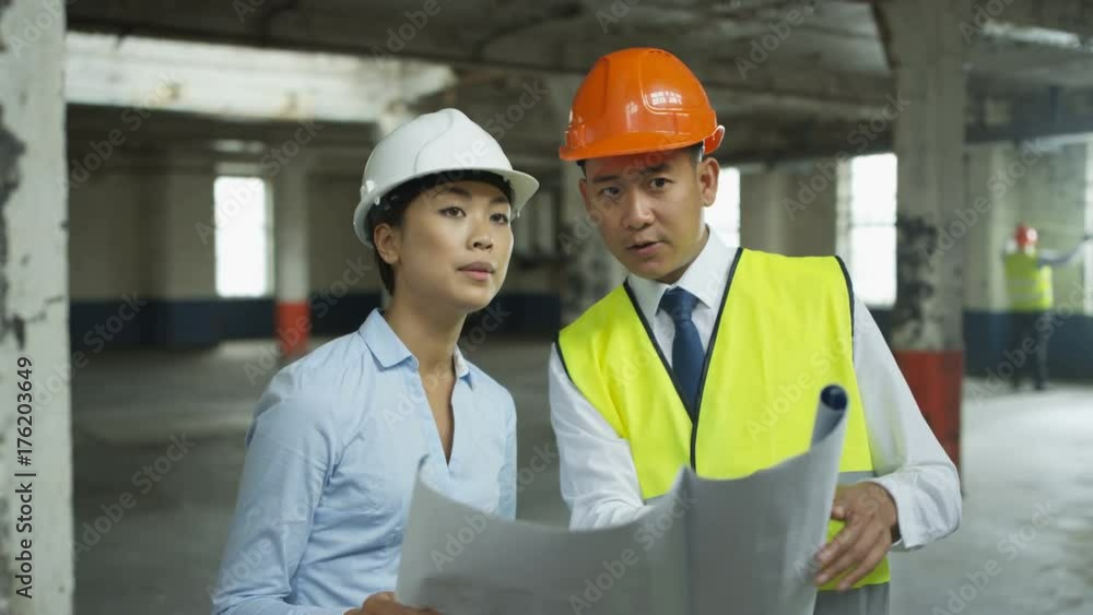Engineers or architects having a discussion at construction site Engineers or architects having a discussion at construction site