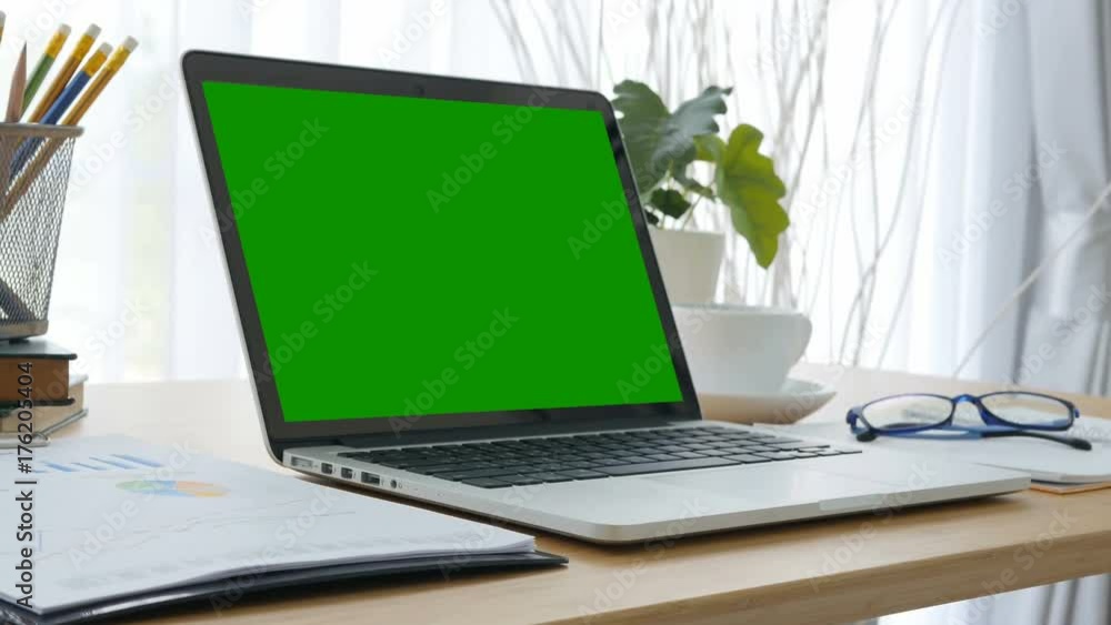 4K : A laptop computer with a key green screen. 4K : A laptop computer with a key green screen.
