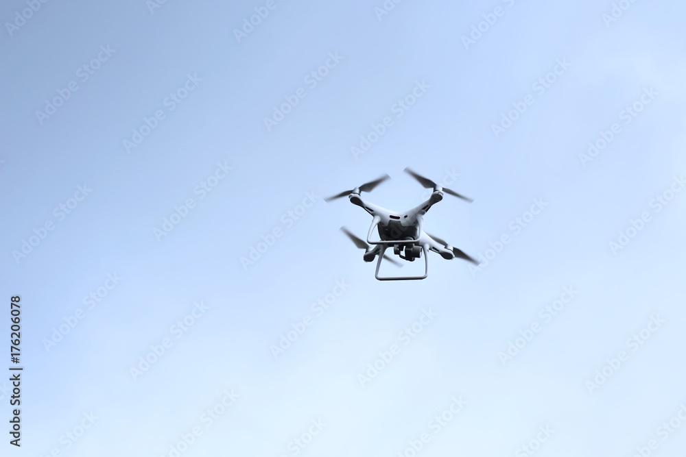 Drone hovering on blue sky Drone hovering on blue sky