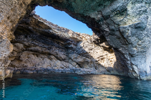Exploring the dramatic huge cliffs and sea caves of south coast of Comino, from sea level on the deep azure crystal clear waters of the Mediterranean, Comino, Malta, June 2017 © mikesmithdesign