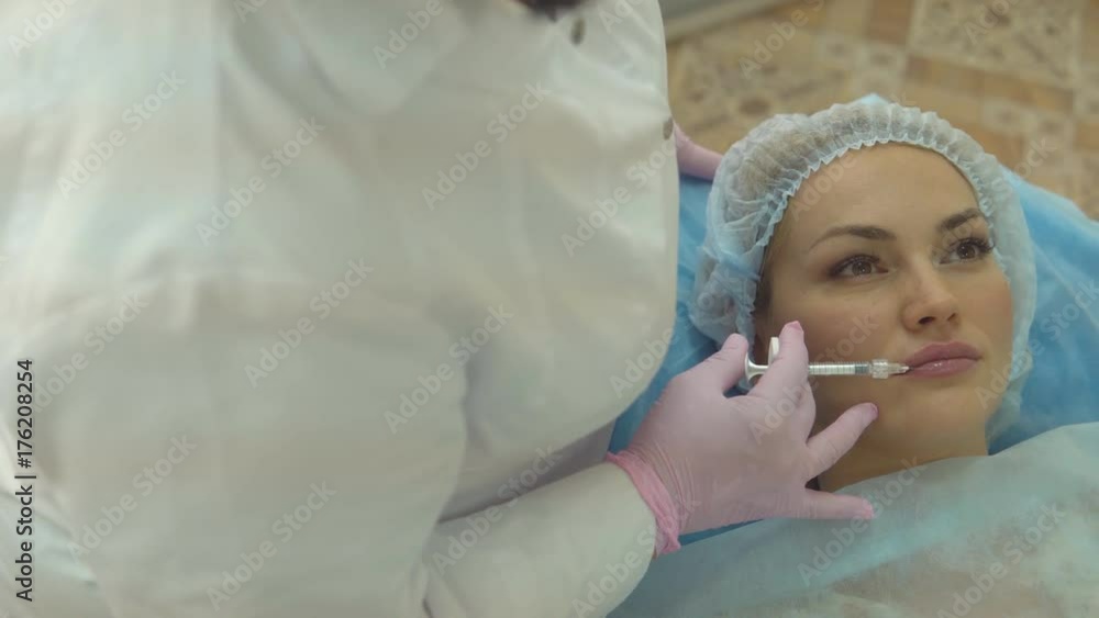 Facial rejuvenation procedure female doctor injects injections of