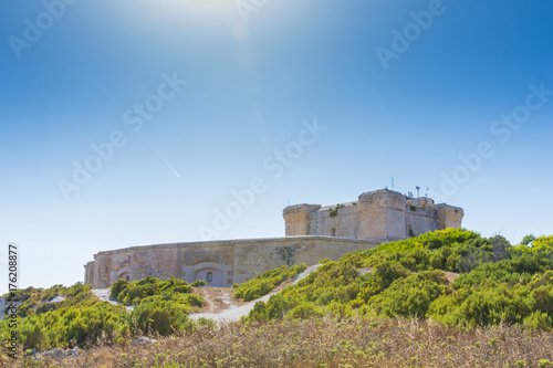 St. Lucians Tower or It-Torri ta' San Lucjan in Maltese, a large fortified Knights of St John watchtower overlooking Marsaxlokk Bay, Malta, June 2017 photo