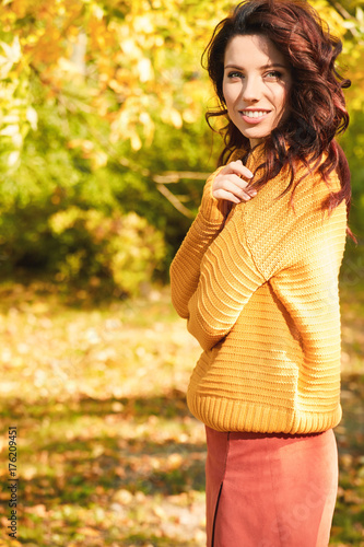 Autumn woman in autumn park. Warm sunny weather. Fall concept