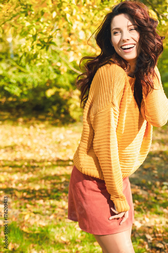 Autumn woman in autumn park. Warm sunny weather. Fall concept