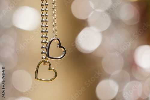 two hearts pendant necklace with glowing blurred background