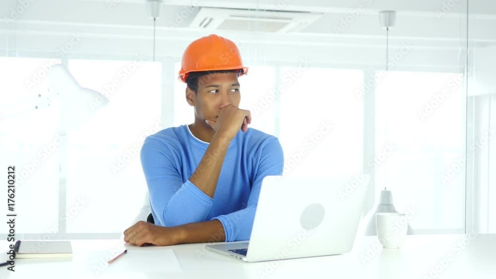 Afro-American Engineer Thinking and Working on Laptop Afro-American Engineer Thinking and Working on Laptop