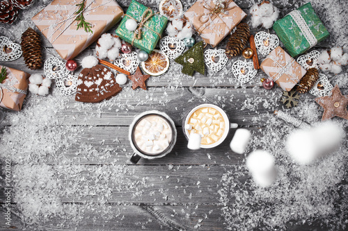 Christmas decorations on an old wooden table. Hot chocolate, cocoa with marshmallows and popcorn on wooden background.