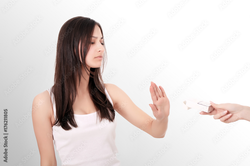 Healthy Young Woman Refusing To Take Cigarette From Pack. Portrait Of Beautiful Female Showing Stop Sign With Hand To Cigarettes. Quit Smoking Concept. High Resolution Healthy Young Woman Refusing To Take Cigarette From Pack. Portrait Of Beautiful Female Showing Stop Sign With Hand To Cigarettes. Quit Smoking Concept. High Resolution