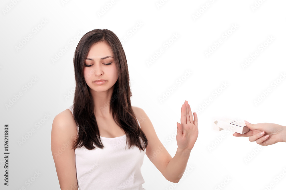 Healthy Young Woman Refusing To Take Cigarette From Pack. Portrait Of Beautiful Female Showing Stop Sign With Hand To Cigarettes. Quit Smoking Concept. High Resolution Healthy Young Woman Refusing To Take Cigarette From Pack. Portrait Of Beautiful Female Showing Stop Sign With Hand To Cigarettes. Quit Smoking Concept. High Resolution