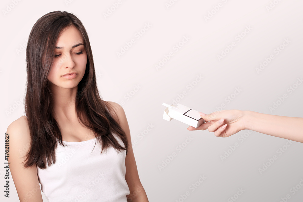 Healthy Young Woman Refusing To Take Cigarette From Pack. Portrait Of Beautiful Female Showing Stop Sign With Hand To Cigarettes. Quit Smoking Concept. High Resolution Healthy Young Woman Refusing To Take Cigarette From Pack. Portrait Of Beautiful Female Showing Stop Sign With Hand To Cigarettes. Quit Smoking Concept. High Resolution