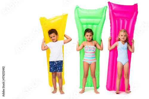 multiethnic kids with swimming mattresses