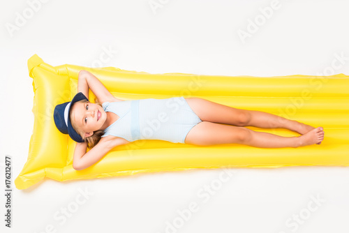 child lying on swimming mattress