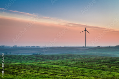Beautiful sunrise at countryside with wind turbine