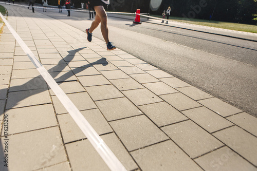 Low section of runner on pavement photo