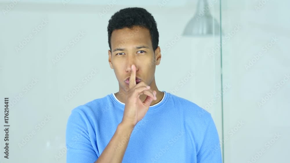 Gesture of Silence by Young Afro-American Man, Finger on Lips Gesture of Silence by Young Afro-American Man, Finger on Lips