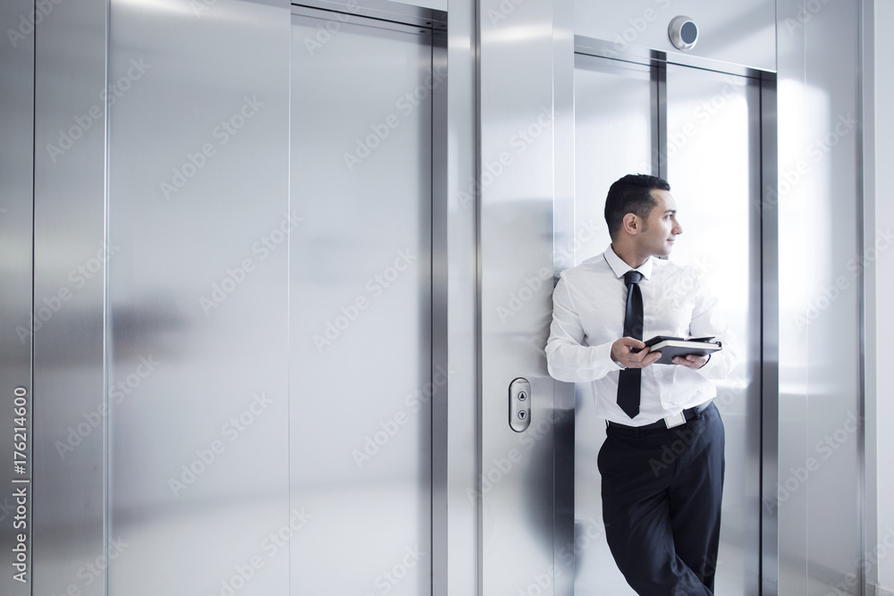 Business man leaning on elevator Business man leaning on elevator
