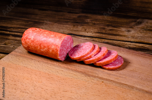 Sliced salami sausage on cutting board
