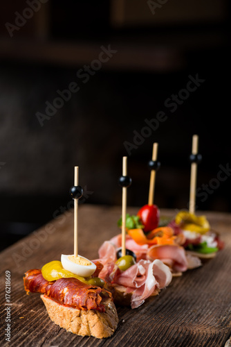 Tapas on Crusty Bread - Selection of Spanish tapas served on a sliced baguette.
