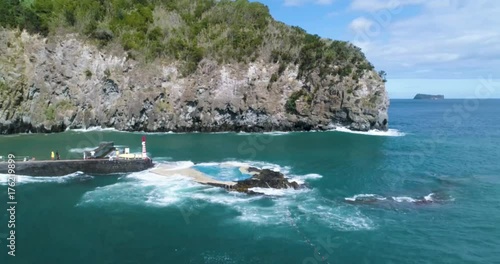 Aerial Drone shot from natural swimming pool nearby rocky coast with waves photo