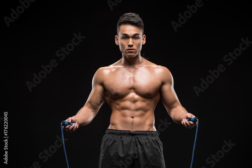 muscular man with skipping rope