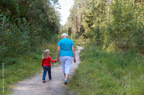 grandmother with granddaughter walk in nature