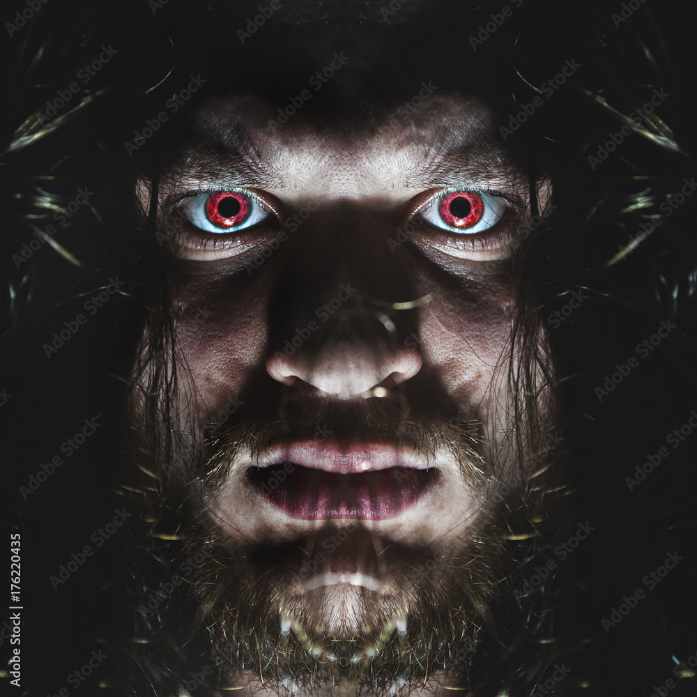Portrait of a man with a red eye for horror or halloween.