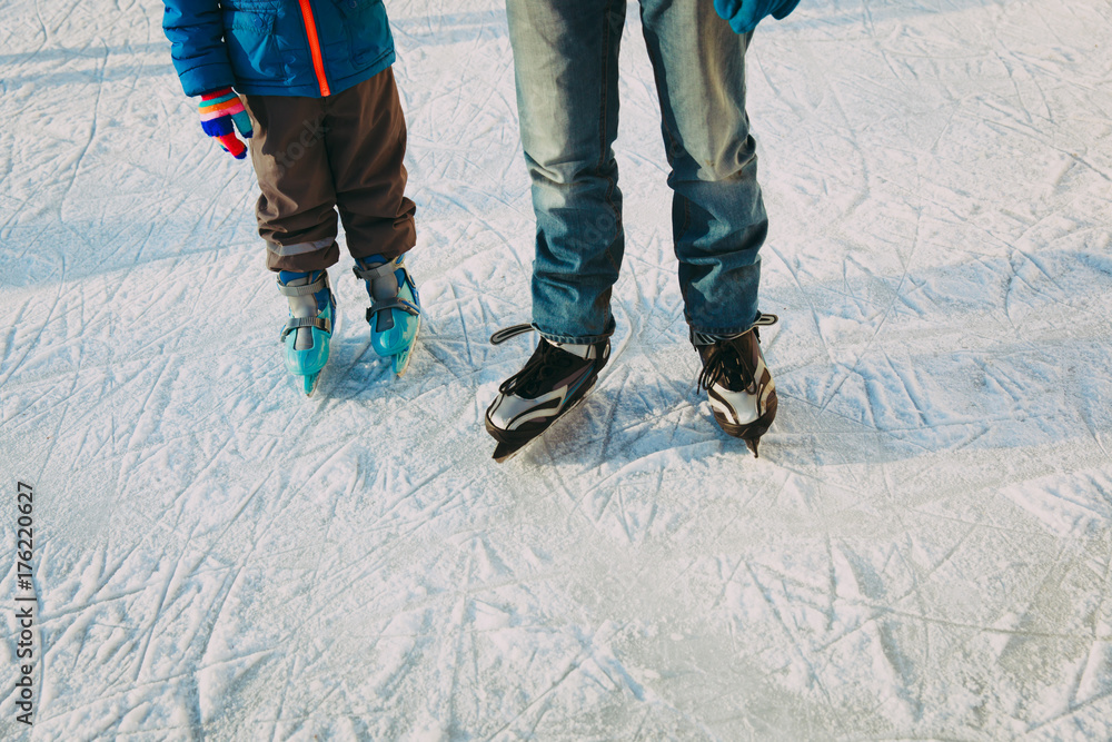 father with little son skating, family winter sport father with little son skating, family winter sport