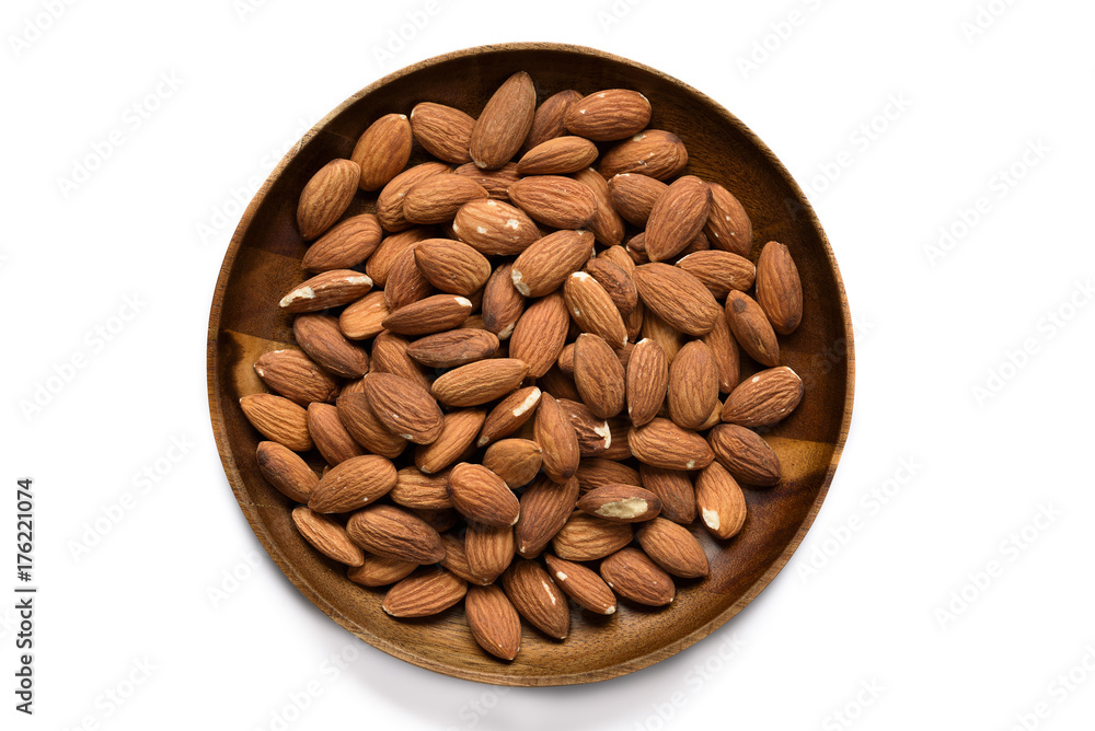 Top view dried almond in wood bowl on white background. Top view dried almond in wood bowl on white background.