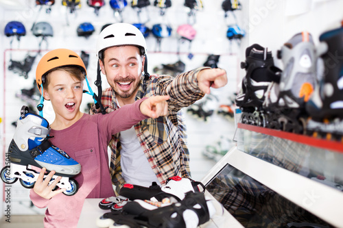 Father and son examining various roller-skates