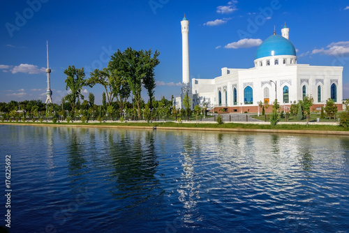 The White Mosque Minor with turquoise dome, one of new sights of Tashkent, located in the new part of the city on the embankment of the Ankhor channel and is surrounded by a landscaped area photo