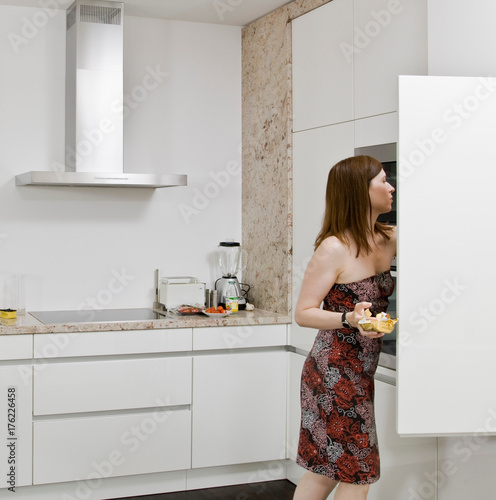 Woman looking for food in the cupboards