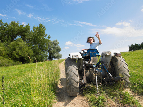 Wallpaper Mural Man driving tractor in field Torontodigital.ca