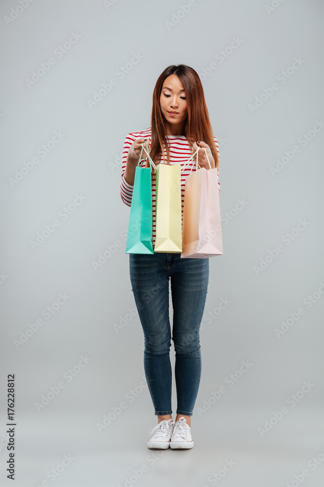 Full length image of pretty asian woman in sweater Full length image of pretty asian woman in sweater