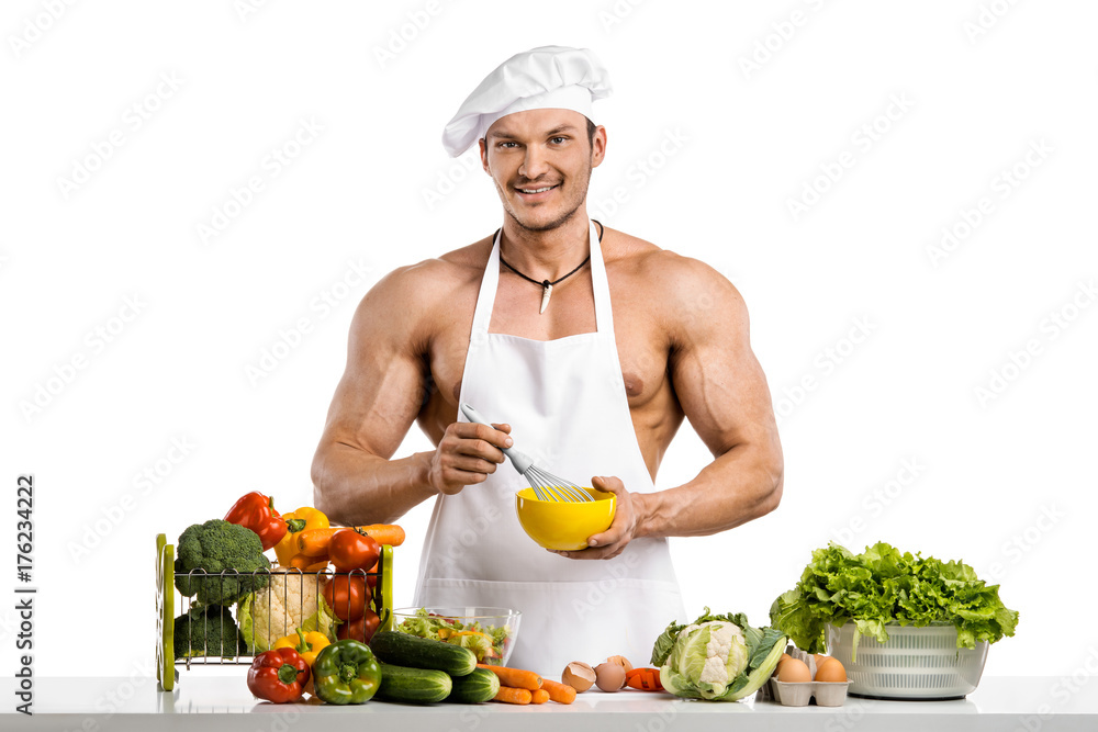 Man bodybuilder in white toque blanche and cook protective apron Man bodybuilder in white toque blanche and cook protective apron