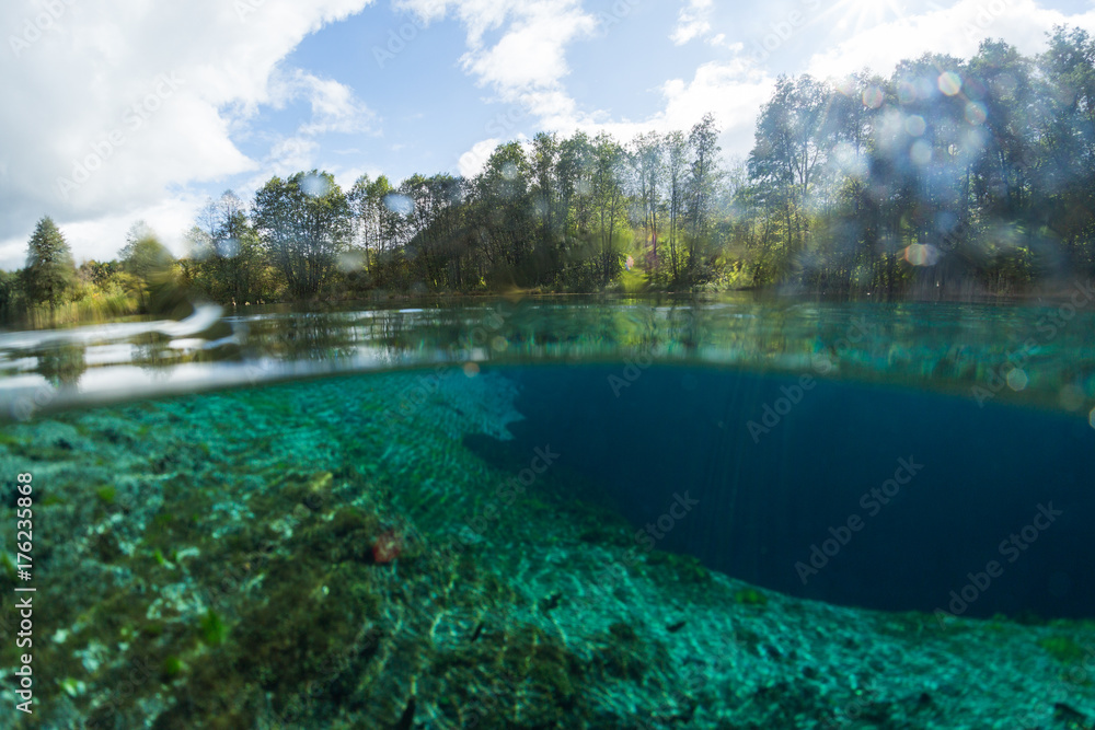 Split underwater view of the karst lake named Goluboye Ozero (Blue Lake) surrounded by forest. Maximum depth is 18m (60ft). Lake is situated near the city of Kazan, Russia