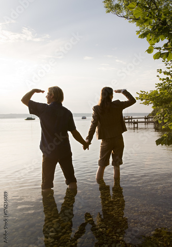 woman and man standing in lake