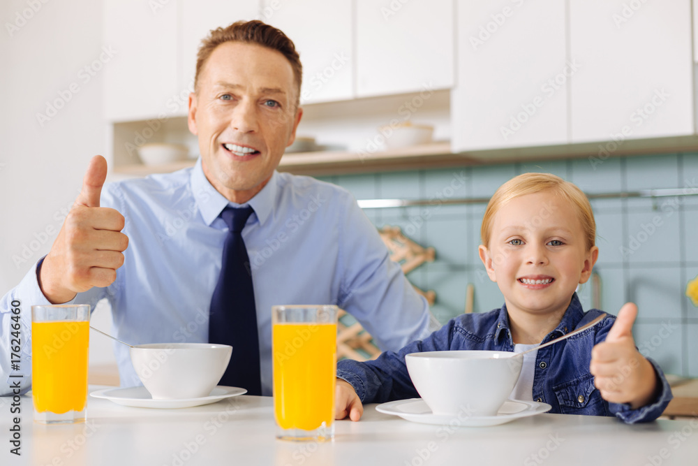 Positive happy father and daughter showing thumbs up gesture Positive happy father and daughter showing thumbs up gesture