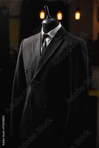 men's suit, shirt, tie on a mannequin in the store