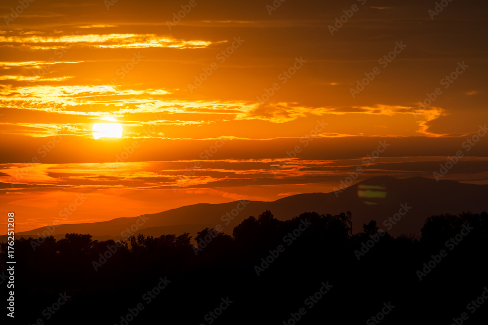Beautiful sunset sky. Sky Background. The setting sun in a cloudy sky background Beautiful sunset sky. Sky Background. The setting sun in a cloudy sky background