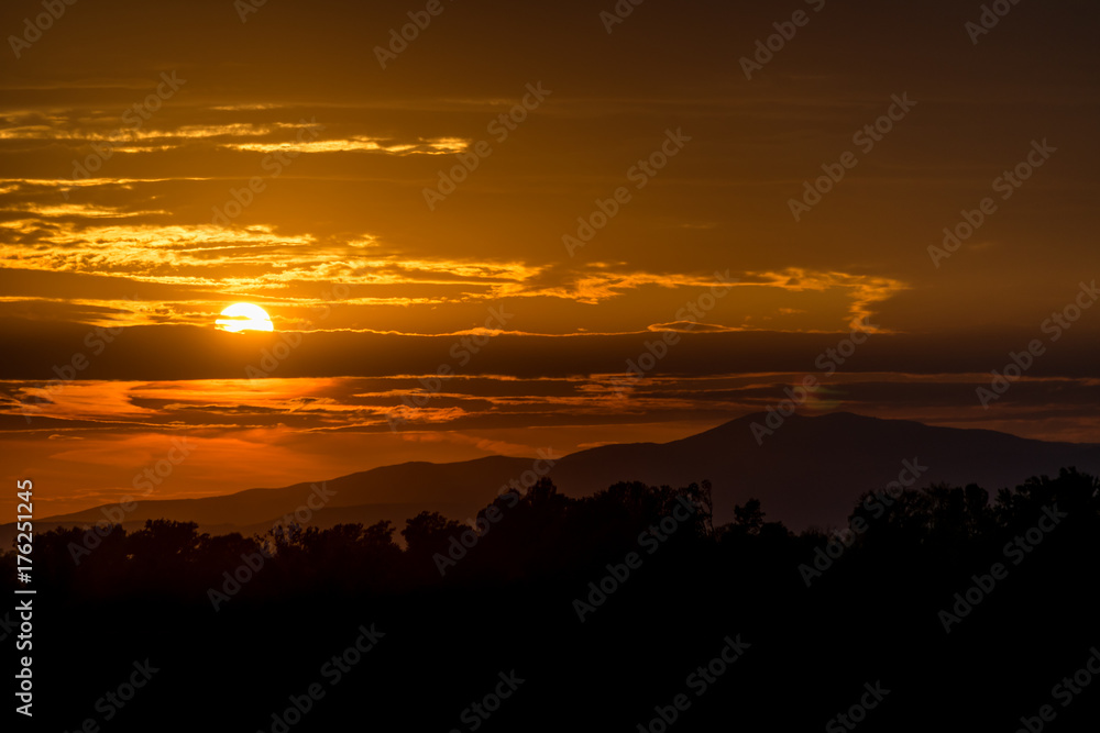 Beautiful sunset sky. Sky Background. The setting sun in a cloudy sky background