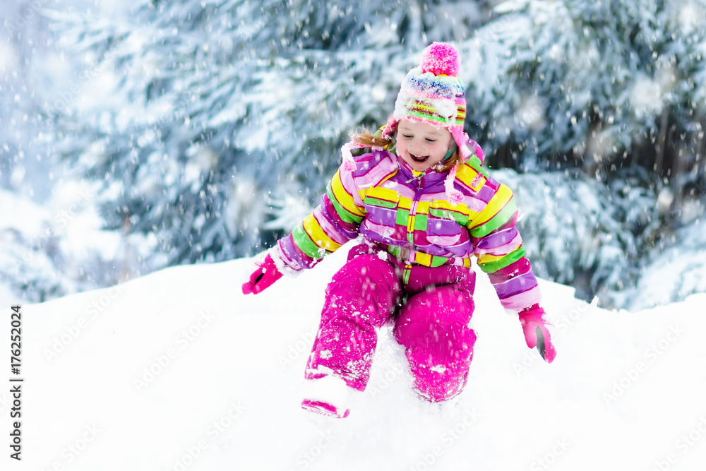 Child playing with snow in winter. Kids outdoors. Child playing with snow in winter. Kids outdoors.