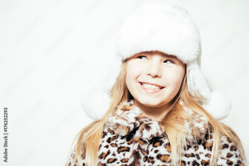 Joyful exciting girl ready for cold winter time on a light background, closeup portrait. Youth, love, happiness and excitement