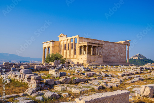 Erechtheion temple in Athens during the sunset. Ruins of the Temple of Erechtheion and Temple of Athene at the Acropolis hill in Greece.